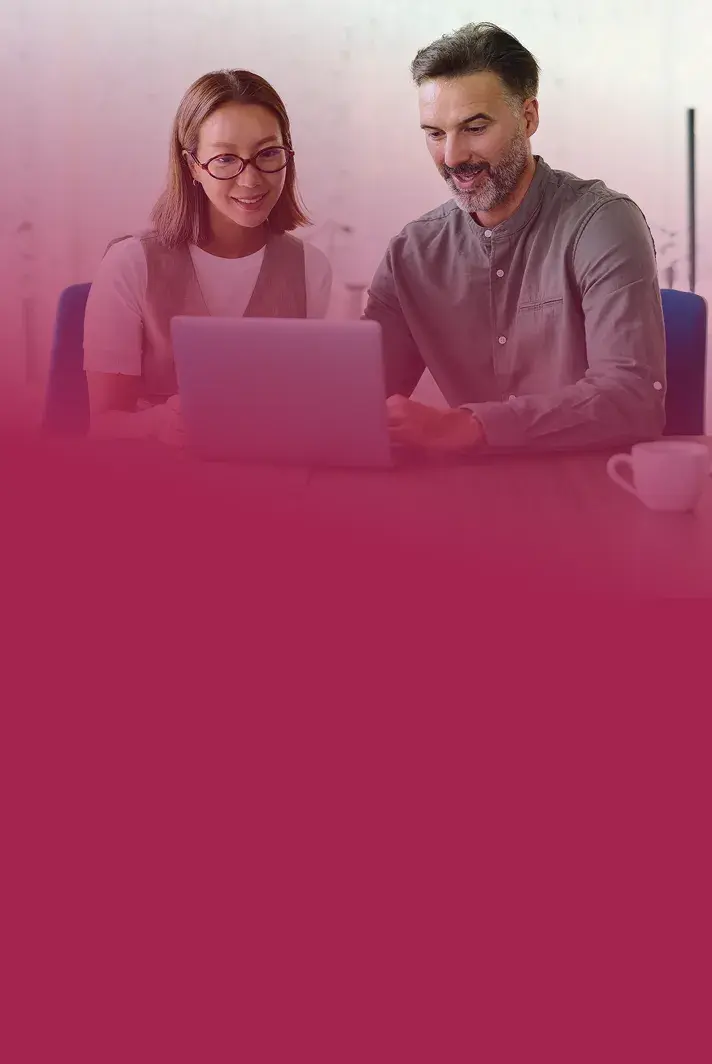 Two colleagues reviewing a health plan together on a laptop